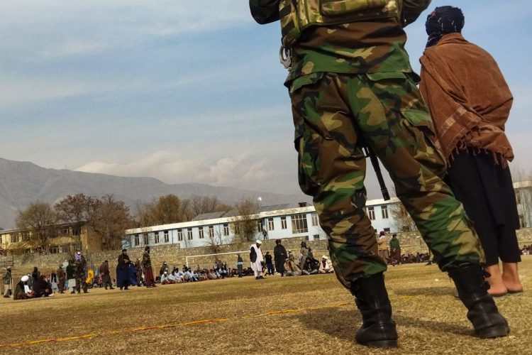 Taliban members oversee a public gathering in Kapisa province, with armed personnel and local citizens present. (Photo Credit: AFP)