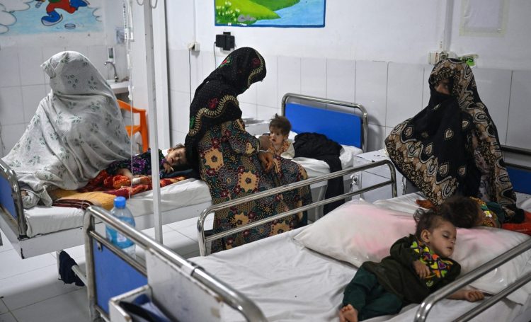 A female hospital ward in Afghanistan where sick children receive care alongside their mothers, reflecting the malnutrition crisis. (Photo Credit: Lillian SUWANRUMPHA / AFP)