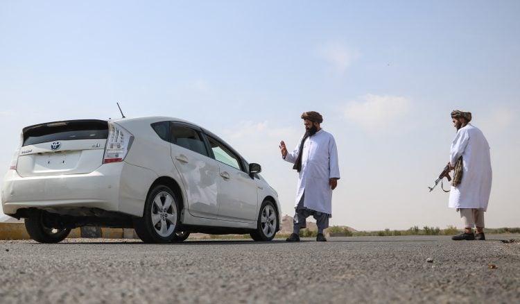 Taliban Morality Police enforce Sharia regulations on the streets of Afghanistan, stopping vehicles for inspections. (Photo Credit: Mohsen KARIMI / AFP)