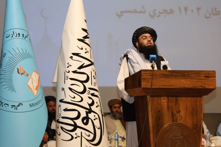 Taliban's Political Deputy Prime Minister, Mawlawi Abdul Kabir, stands behind a stage at an official event of the group. (Photo Credit: Taliban's MOHE)