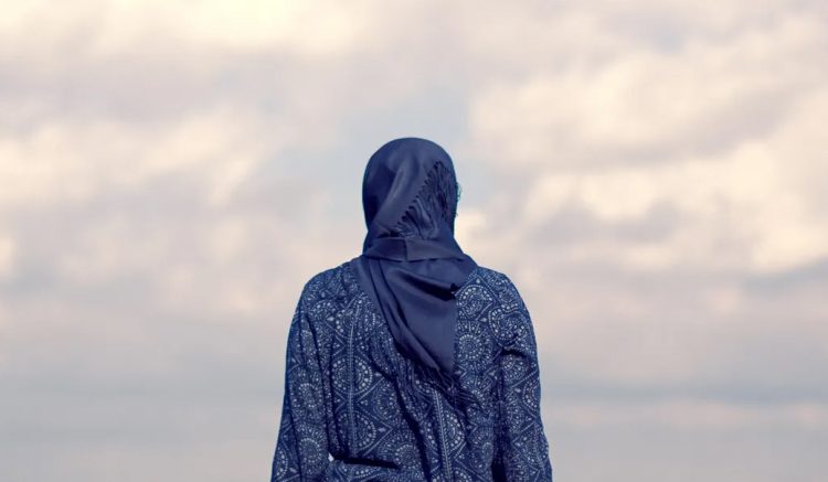 Amidst endless skies, an Afghan woman dreams of freedom and equality, her vision unwavering despite the shadows. (Photo Credit: Getty Images)