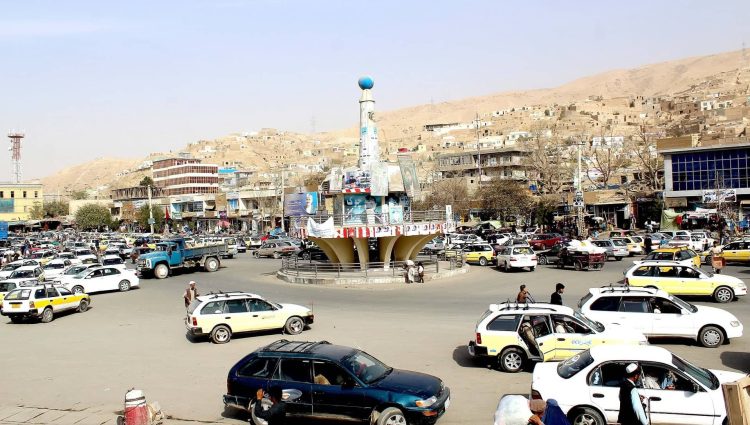 Busy traffic at a roundabout in Baghlan, Afghanistan, with a view of the surrounding buildings and hills. (Photo Credit: Social Media)