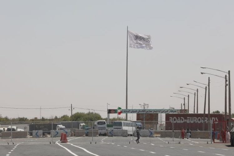 A large Taliban flag waves prominently over the customs port in Nimruz, highlighting the group’s presence amid escalating security concerns. (Photo Credit: Reuters)