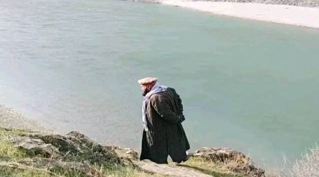 A grieving father searches the Kokcha River for his son's body weeks after a tragic traffic accident. (Photo Credit: Social Media)
