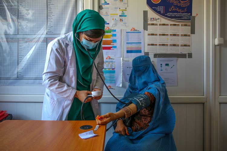 An Afghan midwife checks the blood pressure of a patient at a medical clinic amid growing concerns over maternal health and access to education for female healthcare workers. (Photo Credit: Lynzy Billing)