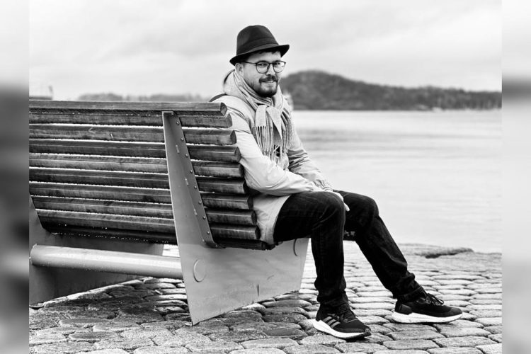 Curator Yama Rahimi pauses by the waterfront. (Photo Credit: Exclusive)