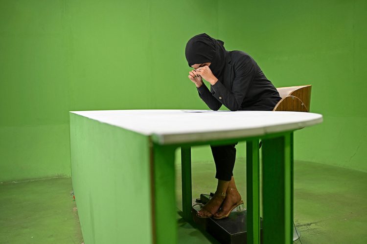 A female journalist in Afghanistan, burdened by censorship and fear, works in a green-screen studio under Taliban rule. (Photo Credit: AFP)
