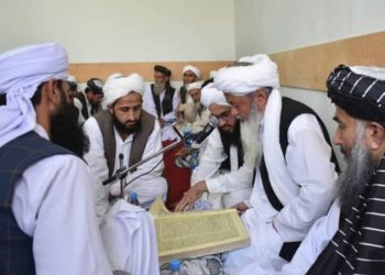 Caption: Taliban clerics gather for a communal study session, engaging in a deep discussion of Islamic texts to guide their community. (Photo Credit: Social Media)