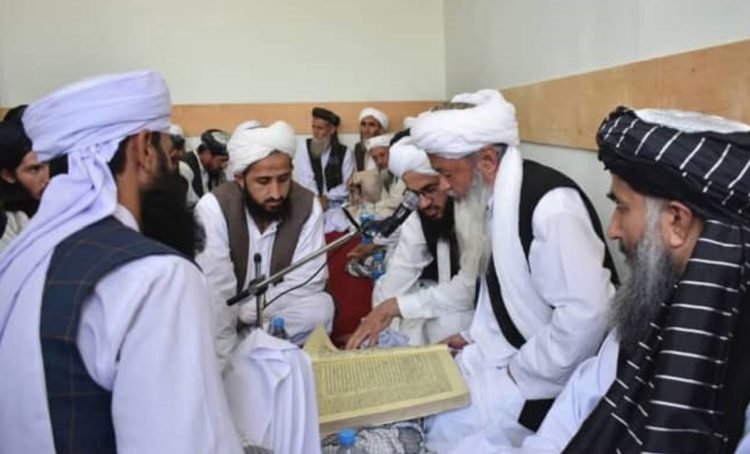 Caption: Taliban clerics gather for a communal study session, engaging in a deep discussion of Islamic texts to guide their community. (Photo Credit: Social Media)