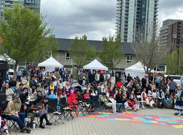 Community members gather to celebrate Hazara Culture Day with vibrant traditional attire, music, and festivities in an outdoor setting. (Photo Credit: Exclusive)