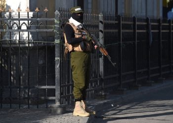 Taliban fighter guards a government building in Kabul. Photo Credit: AFP