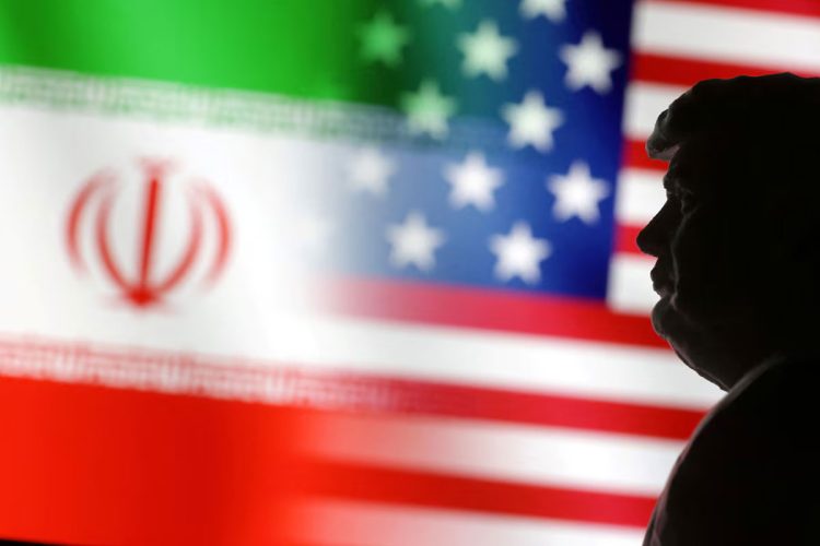 Silhouette of Donald Trump against the backdrop of the Iranian and American flags. (Photo Credit: REUTERS)