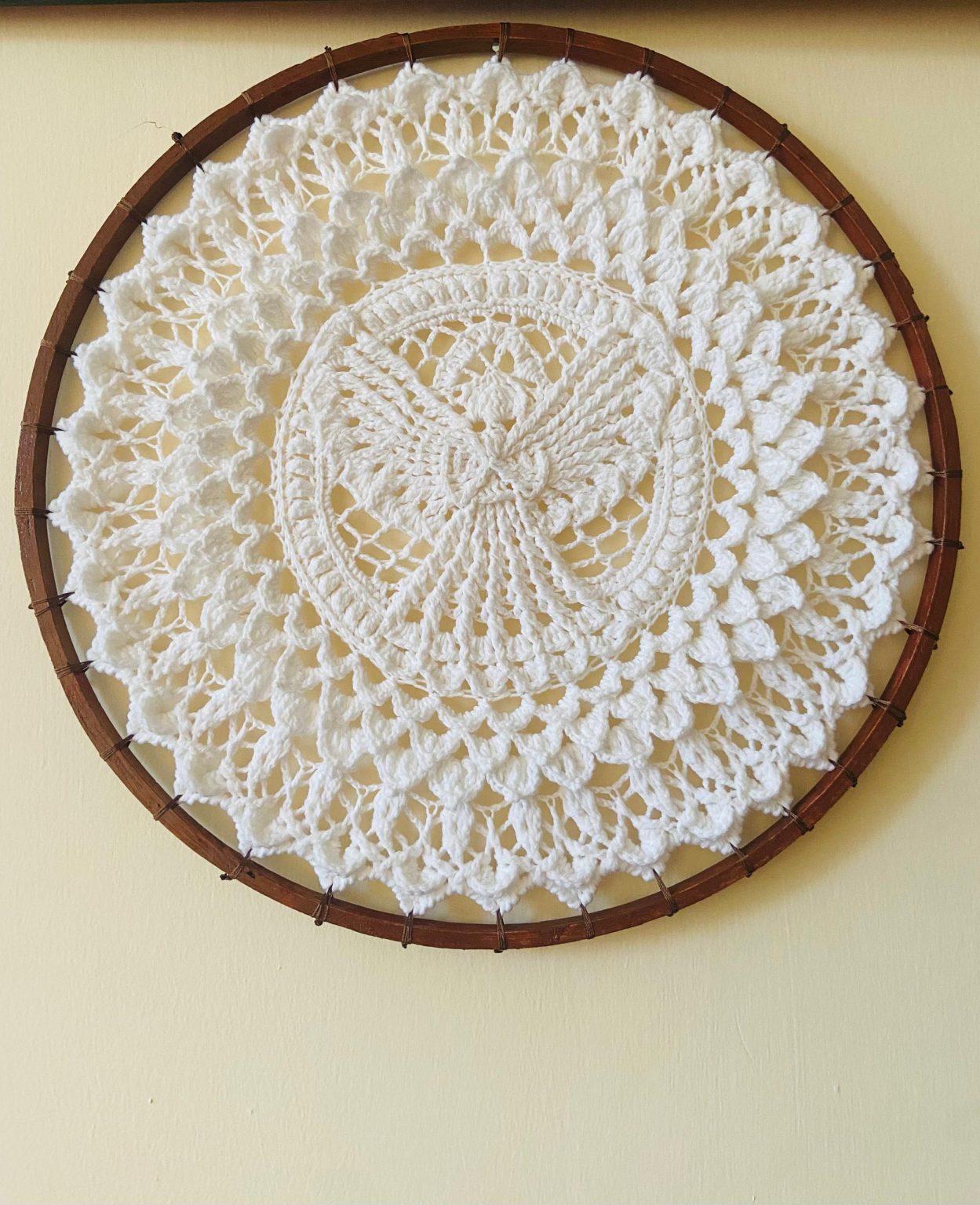 Intricate white crocheted wall art showcasing skilled craftsmanship. (Photo Credit: Exclusive)