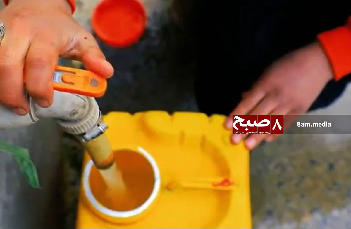 A child operates a tap to fill a container with water in Kabul, reflecting the daily struggle for water access.