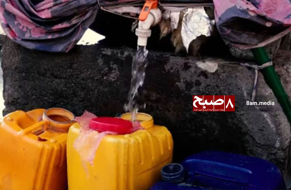 Residents collect water from a limited tap into containers in Kabul, underscoring the severe water scarcity.