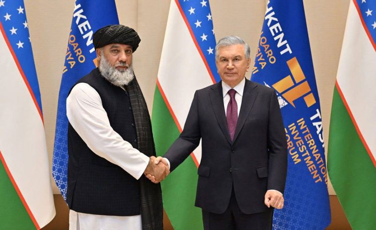 Taliban Minister Nooruddin Azizi shakes hands with Uzbek President Shavkat Mirziyoyev at the Tashkent International Investment Forum. (Photo Credit: MoICAfghanistan)