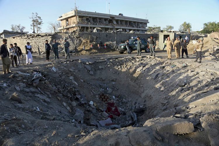 Emergency personnel and officials inspect the crater left by a massive explosion at Zanbaq Square in Kabul, Afghanistan, on May 30, 2017, where a suicide attack claimed over 150 lives and injured more than 400. (Photo Credit: AP)