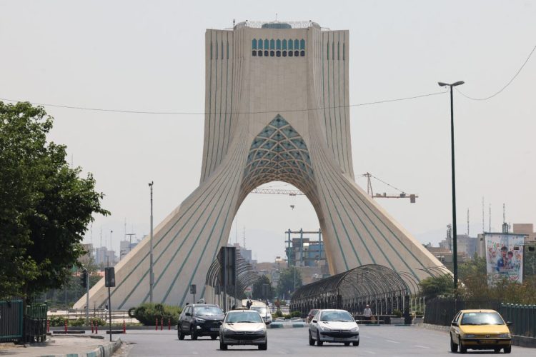 The iconic Azadi Tower stands tall in Tehran, symbolizing Iran's rich history and resilience, as captured on a bustling city morning. (Photo Credit: AFP)