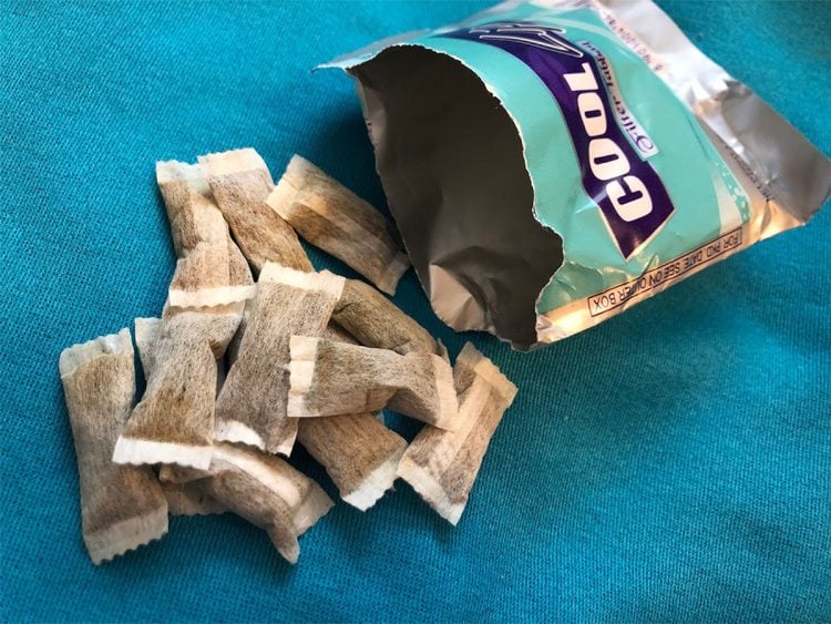 A packet of naswar spilled open, revealing individual portions, highlighting its accessibility and use. (Photo Credit: Snubie)