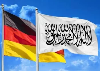 German and Taliban flags side by side against a clear sky, symbolizing recent diplomatic developments. (Photo Credit: Shutterstock)