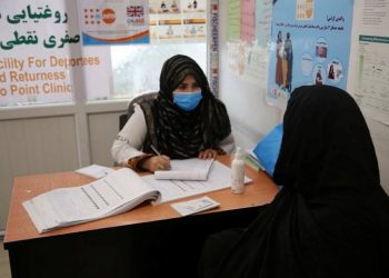 A healthcare worker at the UNFPA clinic in Nimruz provides medical consultation to a woman returning from Iran at the border facility that serves over 80 women daily. (Photo Credit: UNFPA)