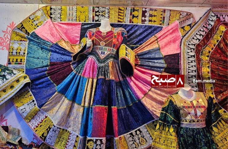 Traditional Afghanistan dresses with intricate embroidery and vibrant colors displayed at a Kabul shop, reflecting the growing trend toward cultural clothing amid changing social dynamics. (Photo Credit: 8am.media)