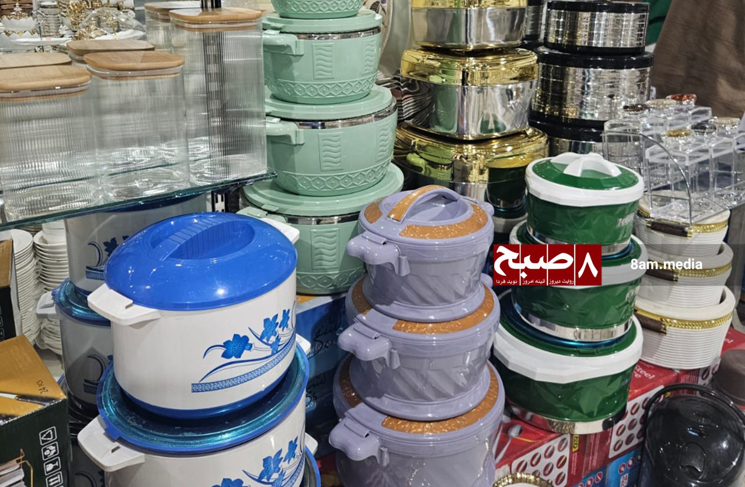 Colorful plastic food storage containers sold at a Kabul market. (Photo Credit: 8am.media)