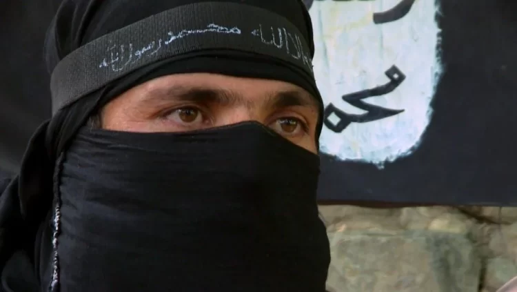 A masked fighter associated with terrorist groups operating in the Afghanistan-Pakistan border region, as referenced in the latest UN Security Council report on ISIS threats. (Photo Credit: PBS)