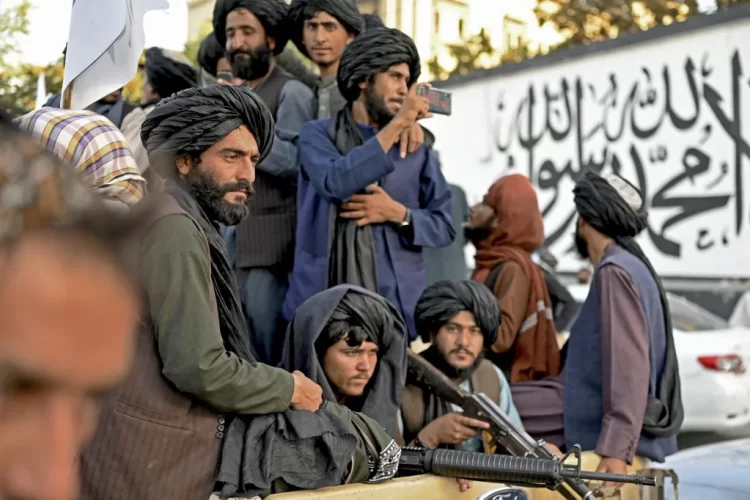 Armed Taliban fighters patrol a street in Kabul, showcasing their presence four years after regaining power. (Photo Credit: Afghanistananalysts)