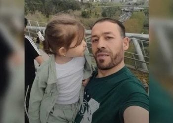 A former Afghan National Directorate of Security (NDS) officer Abdul Rashid with his child, who was reportedly killed by Taliban forces in Badakhshan province's Nasi district after being denied an amnesty card. (Photo Credit: Exclusive)