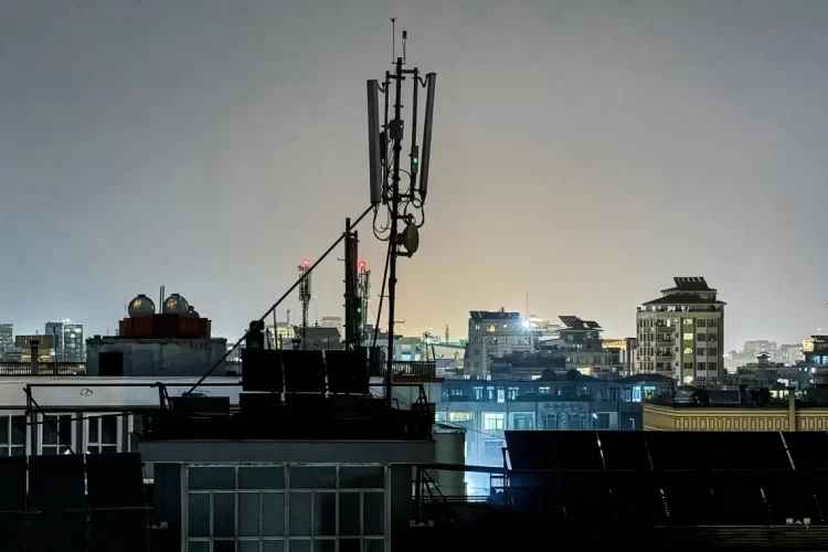 A cell tower stands against the skyline in an urban area, symbolizing telecommunications infrastructure amid Afghanistan's nationwide internet shutdown. (Photo Credit: Getty Images)