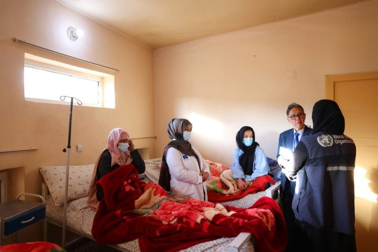 WHO representative Edwin Ceniza Salvador visits a patient at a healthcare facility in Afghanistan as part of efforts to address rising cancer cases among women and broader health challenges facing the country's fragile medical system. (Photo Credit: WHO)