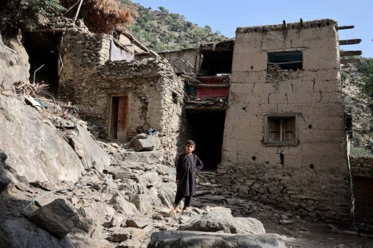 A child stands among earthquake-damaged traditional mud-brick houses in a mountainous village in Afghanistan, where thousands of survivors remain displaced two weeks after deadly tremors struck Kunar Province. (Photo Credit: Reuters)