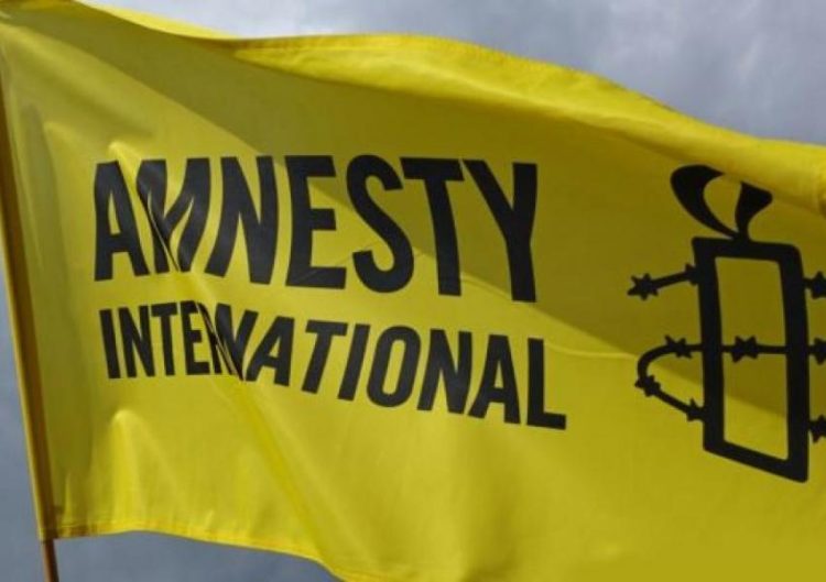 A yellow flag with the Amnesty International logo, symbolizing the organization’s global campaign for human rights and accountability.