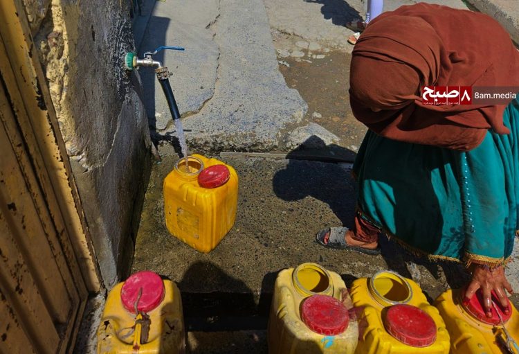 A woman fills water containers from a public tap in Kabul amid the city's worsening water crisis. (Photo Credit: 8am.media)