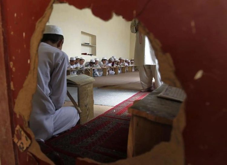 Children study inside a madrassa classroom in Afghanistan. (Photo Credit: HRW)