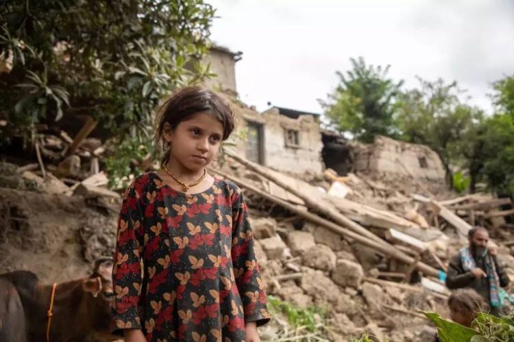 A young girl stands amid the rubble of destroyed buildings in an area affected by the earthquake in eastern Afghanistan. (Photo Credit: UNICEF)