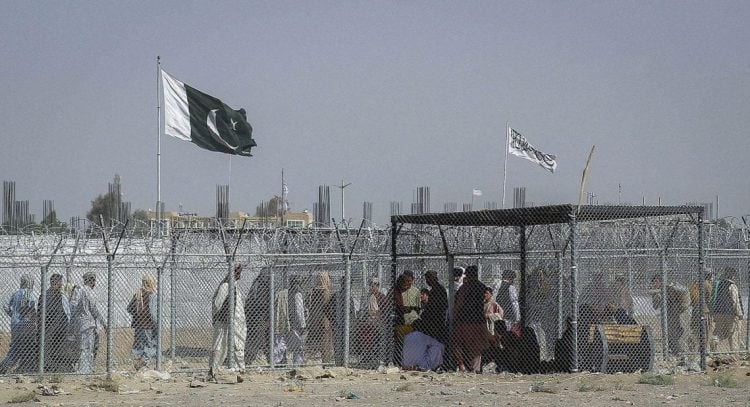 People gather at the Afghanistan-Pakistan border crossing amid heightened tensions between the Taliban and Pakistani authorities, as border closures continue to affect the lives of ordinary citizens caught in escalating conflicts. (Photo Credit: Getty Images)