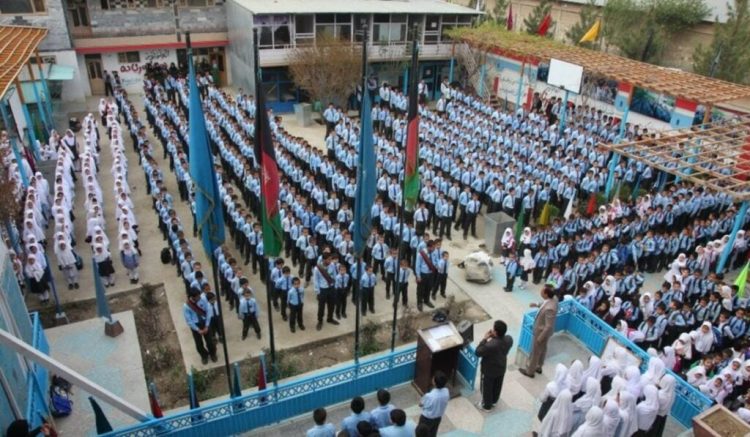 Students gather for a morning assembly at a private school in Afghanistan, where families increasingly struggle with rising tuition fees and additional charges for uniforms, books, and school events. (Photo Credit: Social Media)