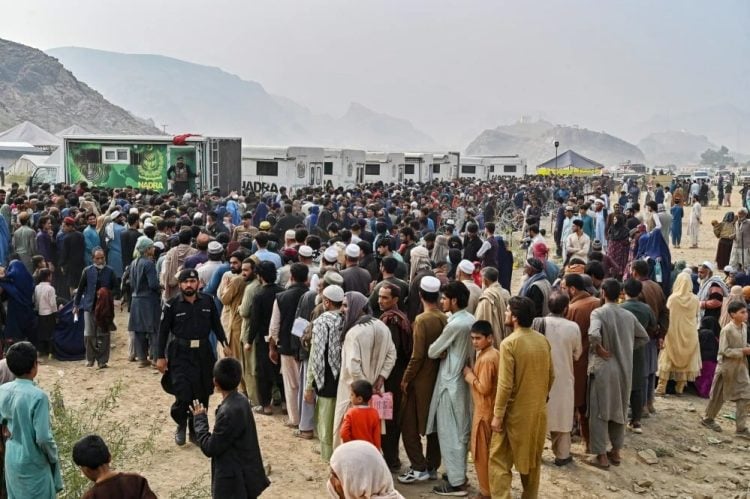 Refugees from Afghanistan queue for registration as Pakistan intensifies deportations. (Photo Credit: AFP)