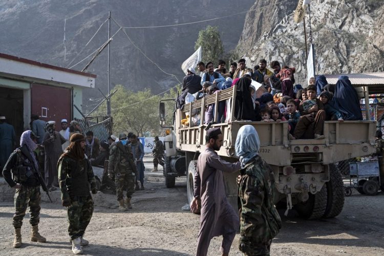 Afghan migrants crowd onto a military truck at a border crossing as they are expelled from Pakistan and return to Afghanistan. (Photo Credit: Wakil KOHSAR / AFP)