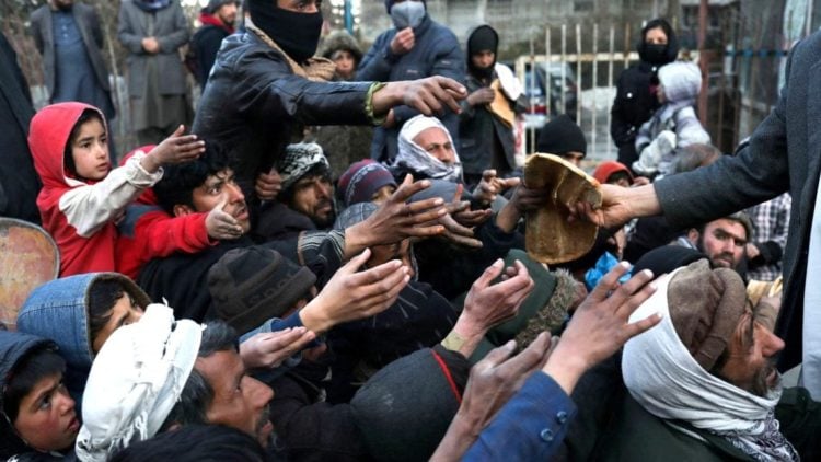 People in Afghanistan reach out for bread during a food distribution. The World Food Programme has identified Afghanistan among countries facing severe hunger crises, warning that more than 300 million people globally will face acute food insecurity in 2026. (Photo Credit: REUTERS)