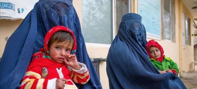 Women in Afghanistan wait with their malnourished children at a health facility as the World Food Programme warns of rising deaths due to severe food insecurity and inadequate nutrition in the country. (Photo Credit: WFP)