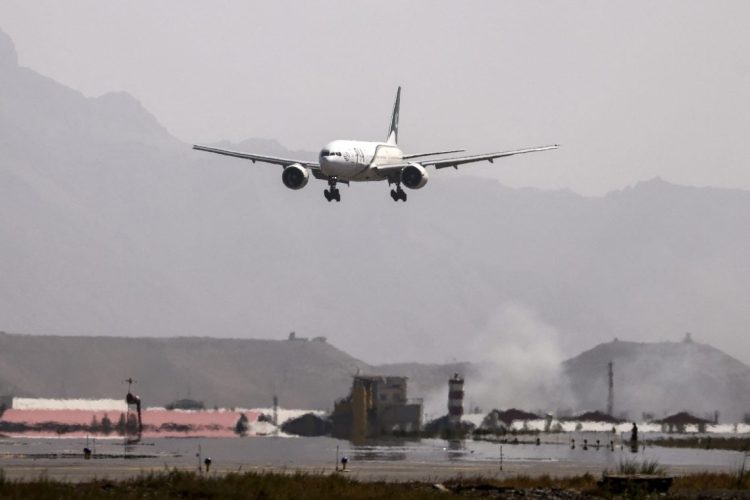 An aircraft approaches for landing at an airport amid mountainous terrain. Austria has deported an Afghan national convicted of drug trafficking to Kabul, marking the second such deportation from the country. (Photo Credit: Karim SAHIB / AFP)