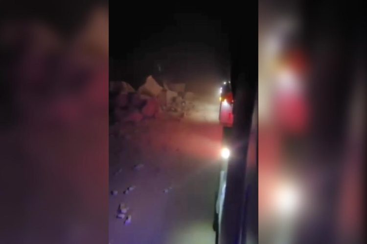 A vehicle navigates through a dusty, debris-filled road in Tashqurghan Gorge after a 6.3-magnitude earthquake triggered landslides that blocked the vital Kabul–Mazar-e-Sharif highway in Balkh Province on Monday night. (Photo Credit: Exclusive)