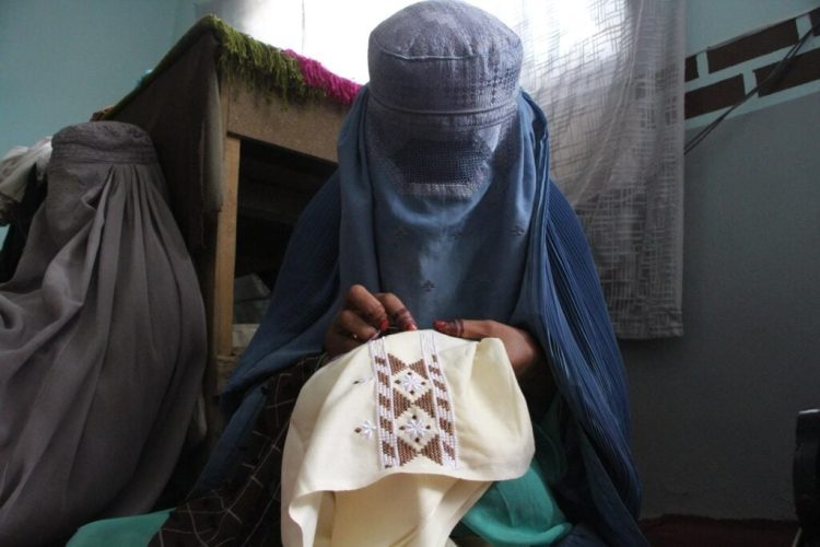A woman stitches to survive under growing restrictions of the Taliban. (Photo Credit: Afghan Times)