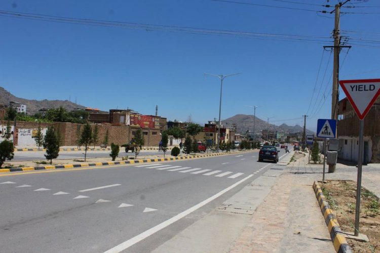 A well-maintained street in Afghanistan showcasing modern road infrastructure with clear traffic markings, pedestrian crossings, and safety signage, exemplifying the type of urban planning improvements needed to reduce traffic accidents. (Photo Credit: UN-Habitat)