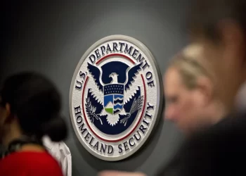 Department of Homeland Security seal displayed at an immigration facility, as Afghan asylum cases face increased scrutiny under new administration policies. (Photo Credit: Bloomberg)