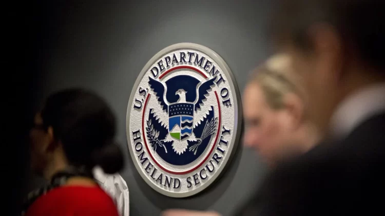 Department of Homeland Security seal displayed at an immigration facility, as Afghan asylum cases face increased scrutiny under new administration policies. (Photo Credit: Bloomberg)