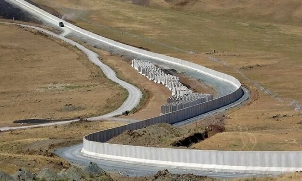 A concrete border wall winds through mountainous terrain, part of the extensive fortification projects undertaken by Afghanistan's neighbors to control cross-border movement and address security threats. (Photo Credit: Social Media)
